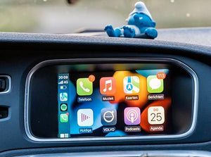 Apple CarPlay interface seamlessly integrated into a Volvo vehicle, displaying navigation, communication features, and media apps on the touchscreen.