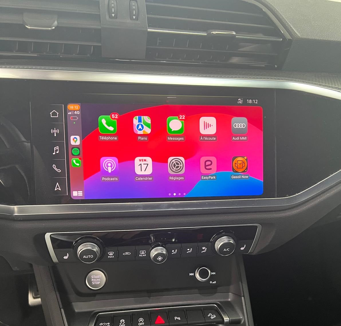 Car dashboard with a touchscreen display showing app icons