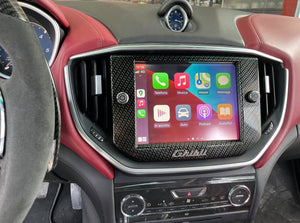 Apple CarPlay module seamlessly integrated into a Maserati luxury car, featuring navigation, communication, and media apps on the touchscreen interface.