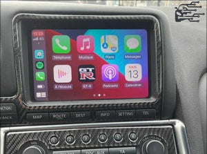 Apple CarPlay system integrated into a Nissan vehicle, displaying navigation, communication features, and media apps on the touchscreen interface.