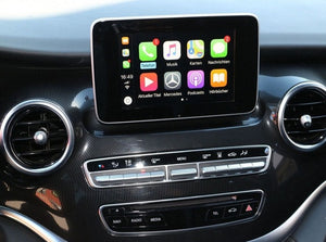 Apple CarPlay interface integrated into a Mercedes-Benz vehicle, showcasing navigation, communication, and media apps on the touchscreen.