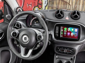 Apple CarPlay interface integrated into a Smart car, displaying navigation, communication features, and media apps on its touchscreen interface.